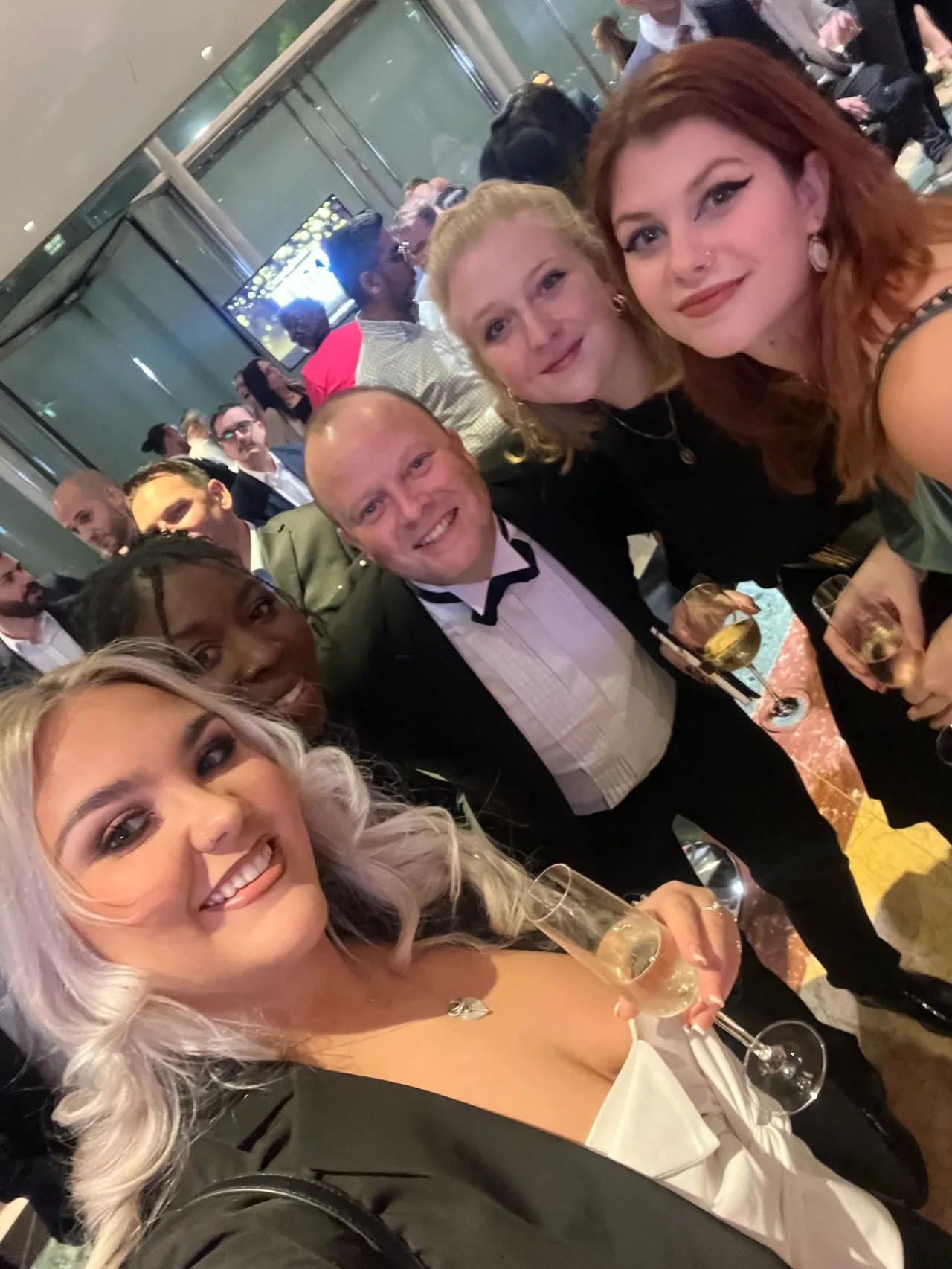 Work event selfie of 5 colleagues in formal wear