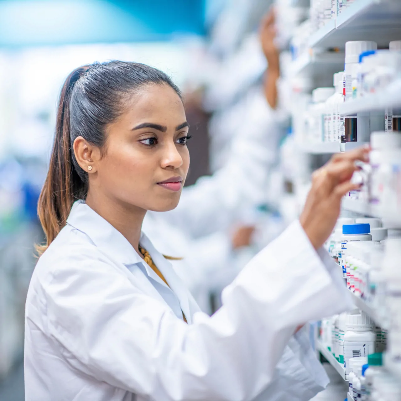 Pharmacy dispenser talking to patient